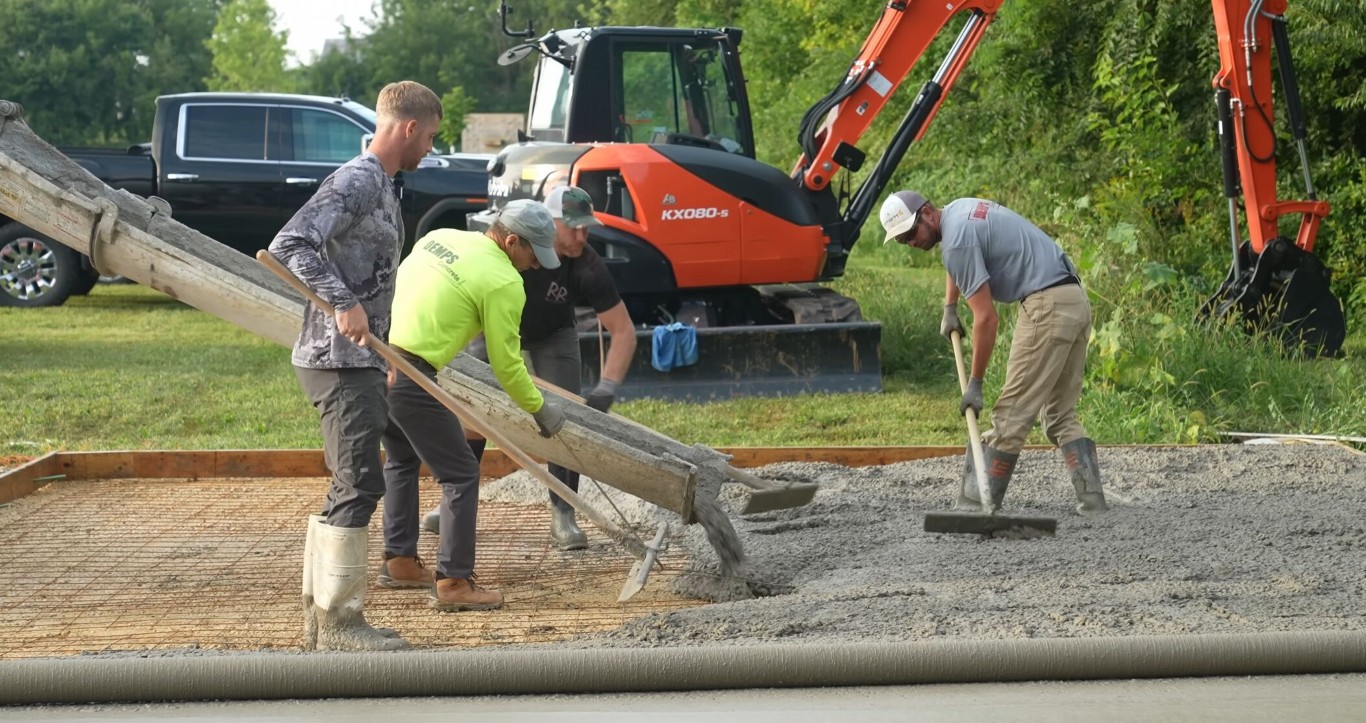 Concrete contractor crew pouring and spreading a concrete foundation in Camarillo, CA