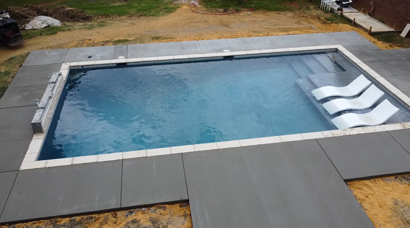 Smooth decorative concrete pool deck surrounding a residential swimming pool in Camarillo, CA