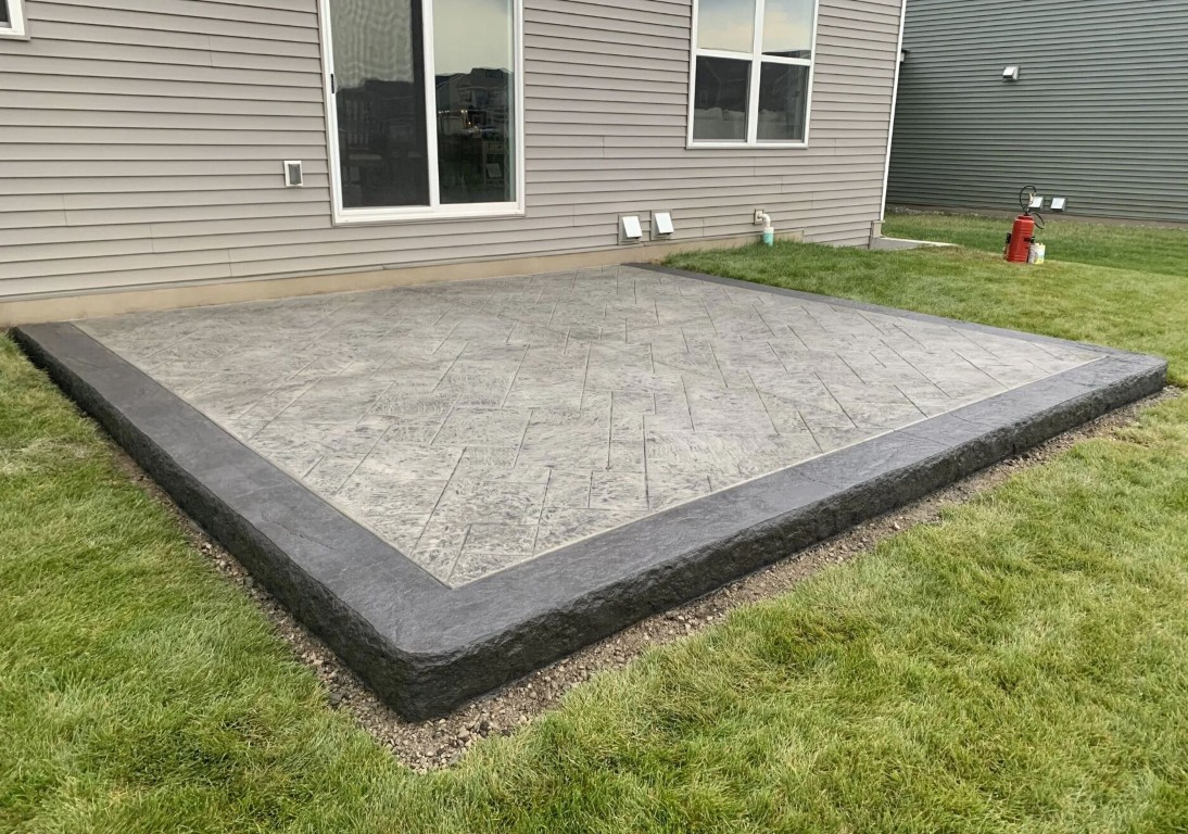Stamped concrete patio with charcoal border and herringbone pattern installed in Camarillo, CA